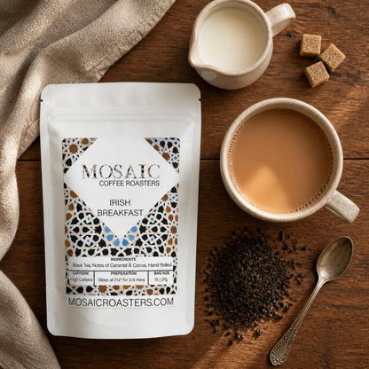 Irish Breakfast tea pouch flat lay with a cup of tea with milk